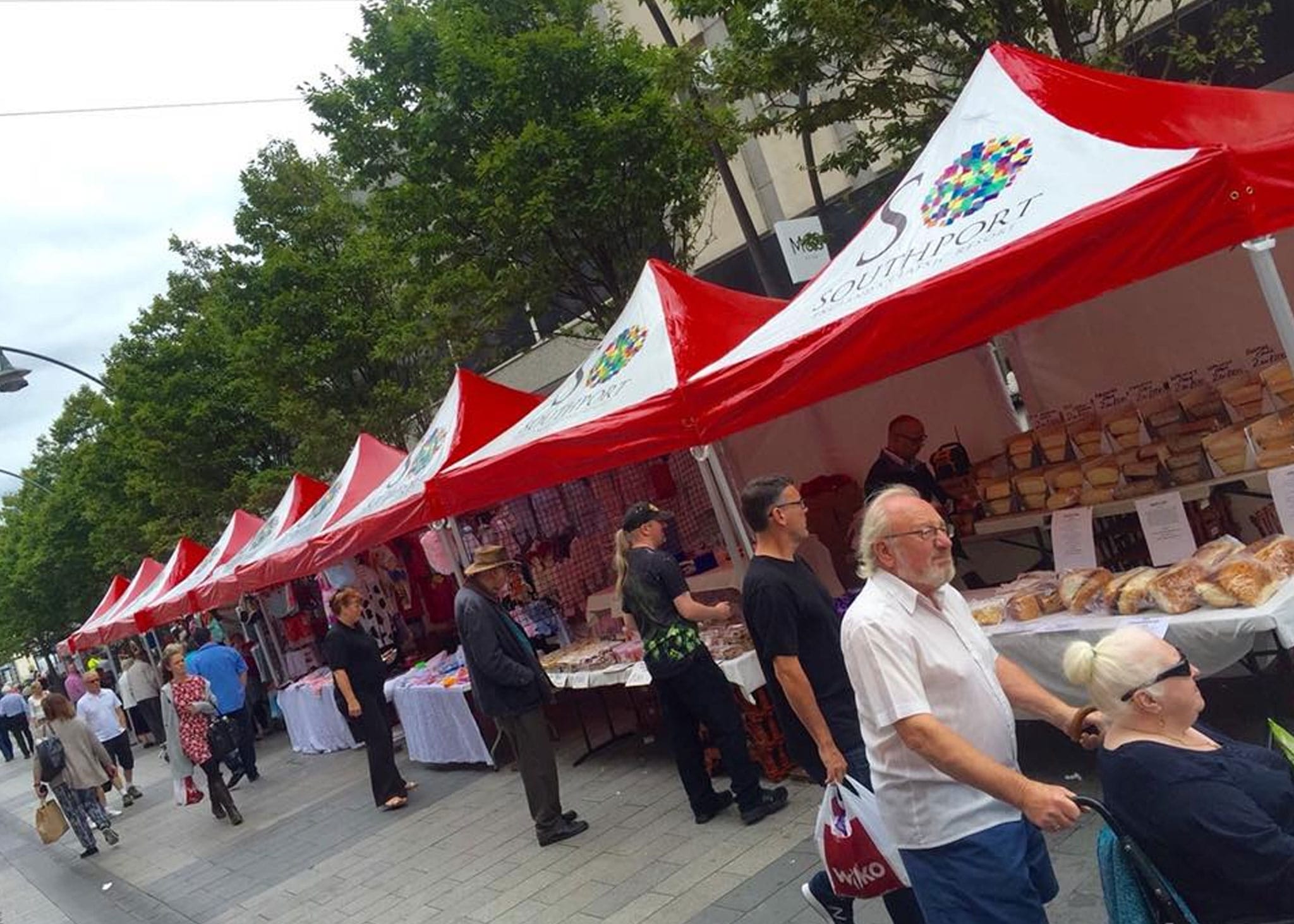busy market with branded gazebos