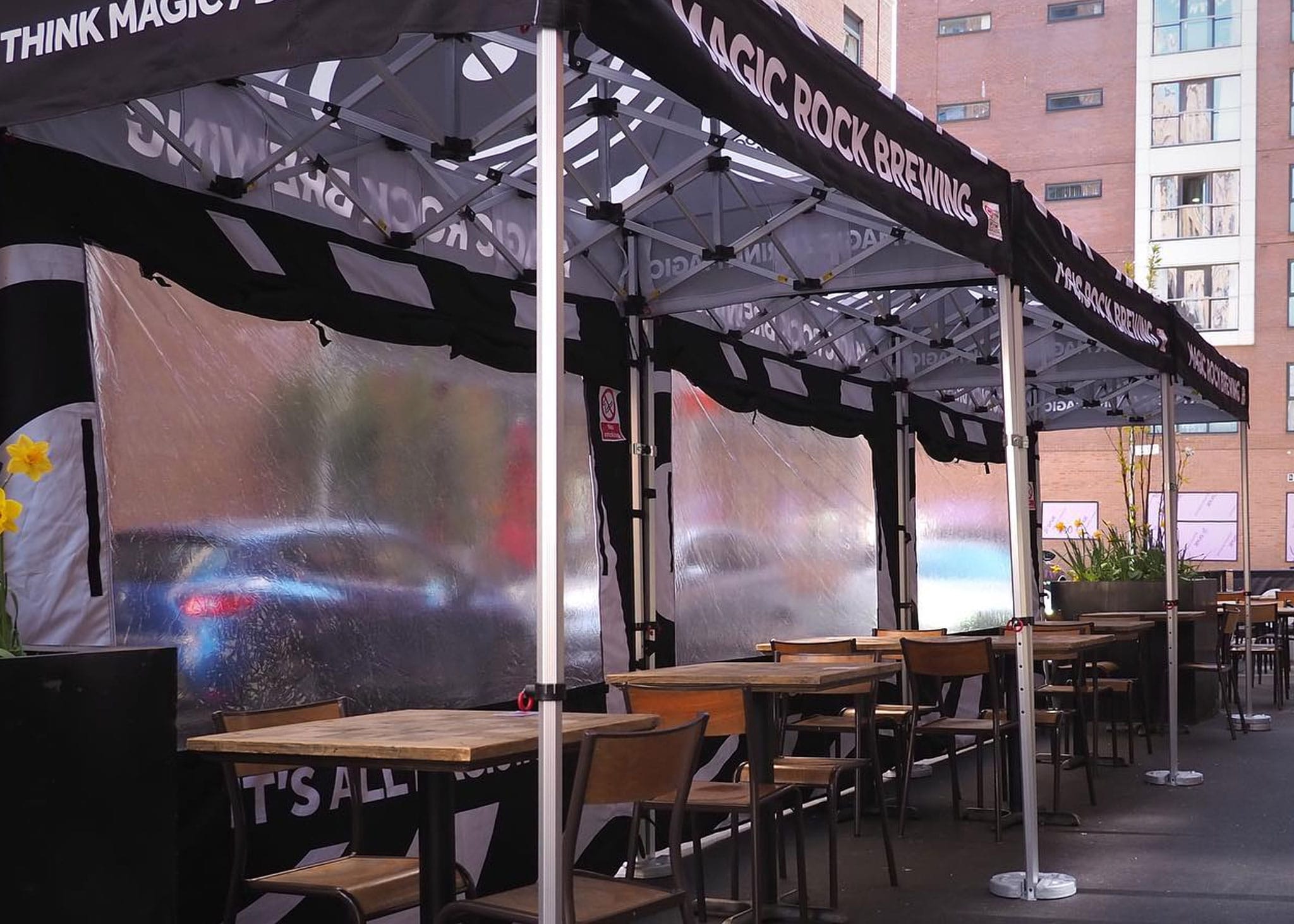 Outdoor dining area covered with pop up gazebos