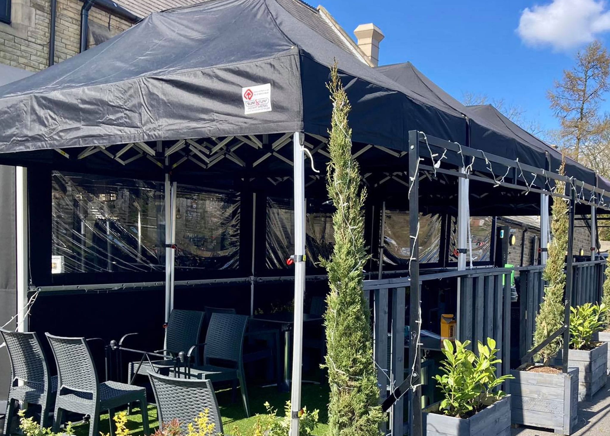 pop‑up gazebos used by a pub for winter seating