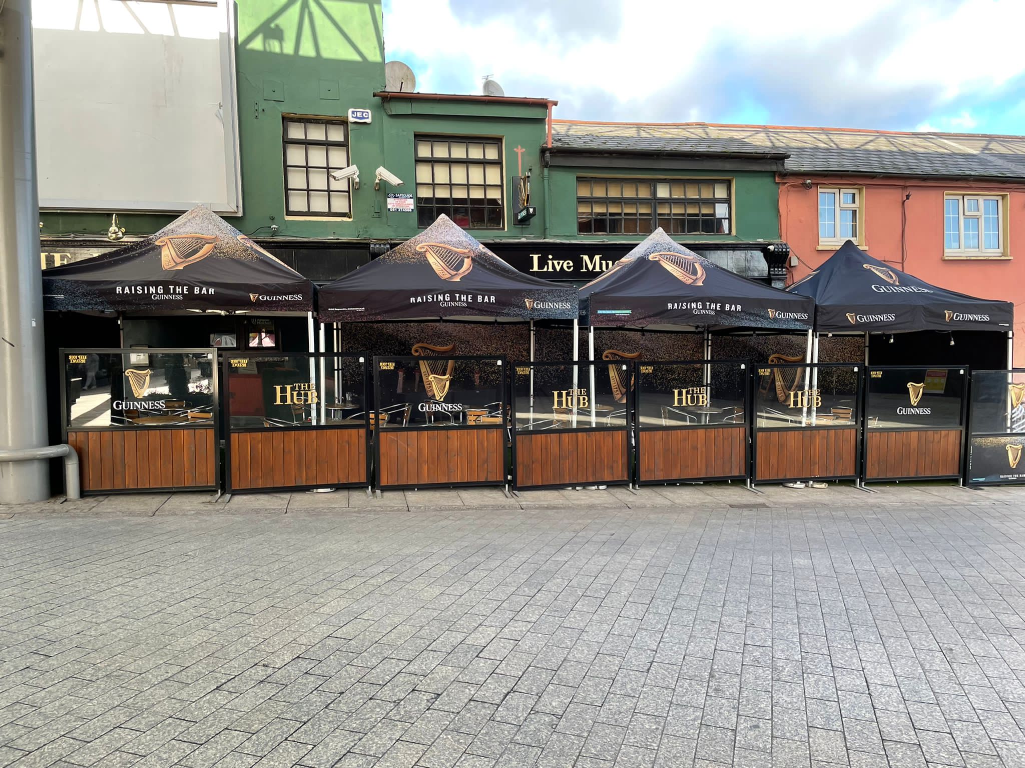 Guinness gazebos covering pub outdoor seating area
